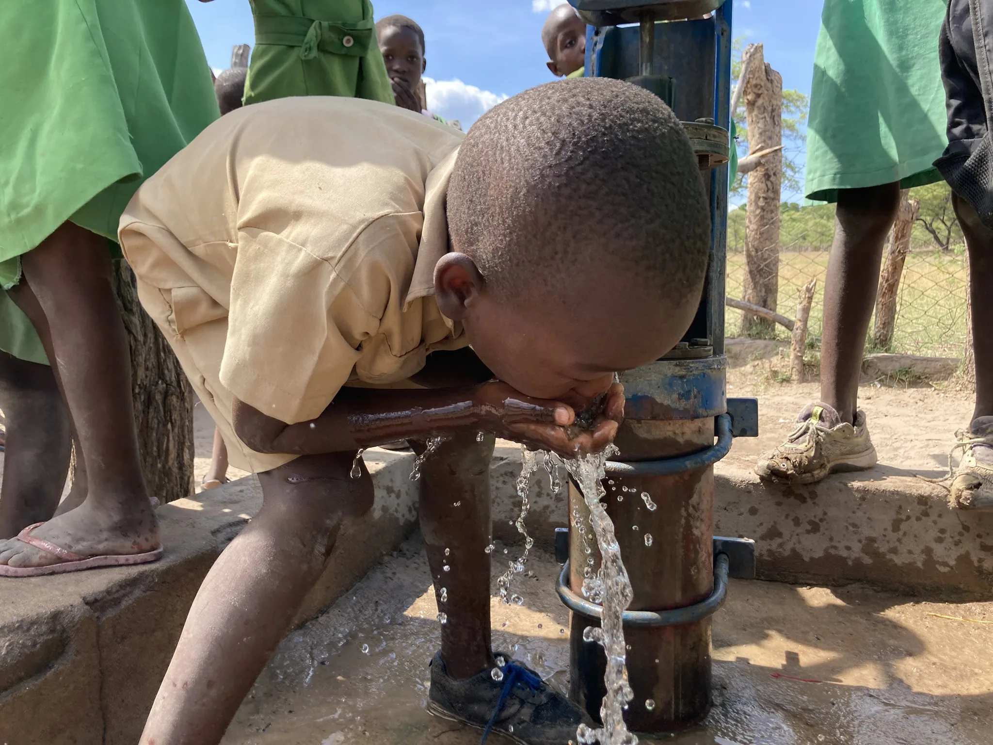 Zim people water drinking boy